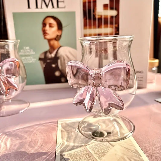 Wine glass with pink bow design on a magazine